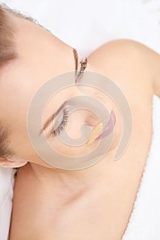 Unwanted hair wax epilation. Young Woman. cosmetology salon treatment procedure. Home waxing