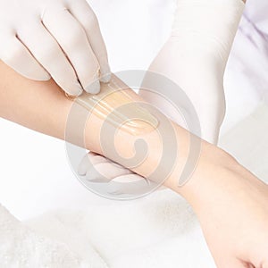 Unwanted hair wax epilation. Young Woman. cosmetology salon treatment procedure. Home waxing