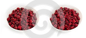 Unwashed and washed raspberries in white deep plates on a white background.