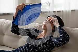 Unwell Asian woman use waver suffer from heatstroke