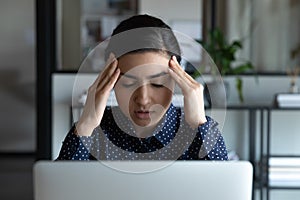 Unwell Indian female employee suffer form headache