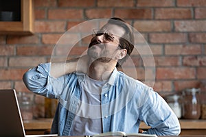 Unwell man suffer from backache working on computer