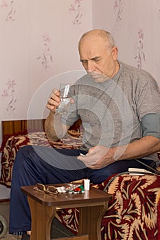 Unwell senior man taking medication