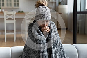 Unwell woman feel cold in home with no heating photo