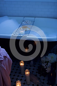 Unwind in foaming bubble bath with tea, lit candles and flowers