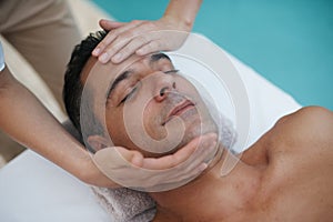 Unwinding those stiff neck muscles. a handsome man enjoying a massage at a spa.