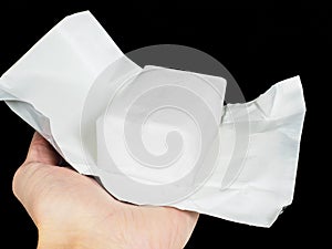 Unwrapped block of coconut fat in aluminum paper