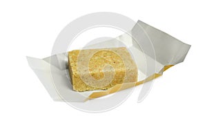Unwrapped bouillon cube on white background. Broth concentrate