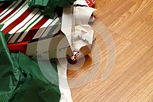 Unwrapped Christmas Gifts and Torn Wrapping Paper photo