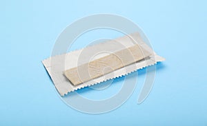 Unwrapped stick of chewing gum on light blue background