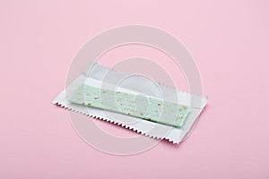 Unwrapped stick of chewing gum on pink background, closeup