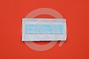 Unwrapped stick of tasty chewing gum on red background, top view