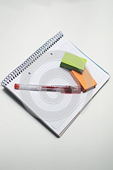 Unwritten notebook with a red pen and colorful notes on it photo