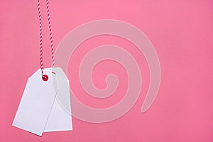 Unwritten white tags on a pink background photo