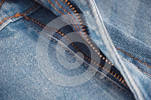 An unzipped zipper on a pair of jeans