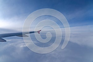 Up in the air, view of aircraft wing silhouette with dark blue sky horizon