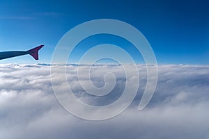 Up in the air, view of aircraft wing silhouette with dark blue sky horizon