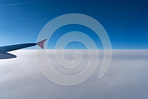 Up in the air, view of aircraft wing silhouette with dark blue sky horizon