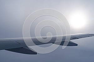 Up in the air, view of aircraft wing silhouette with dark blue sky horizon