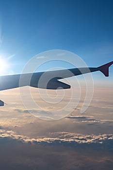 Up in the air, view of aircraft wing silhouette with dark blue sky horizon