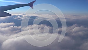 Up in the air, view of aircraft wing silhouette with dark blue sky horizon