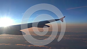 Up in the air, view of aircraft wing silhouette with dark blue sky horizon