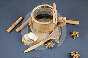 Up of black coffee and spices on a blue background