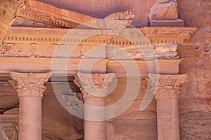 Up close facade of red rose-colored Treasury of Petra, Jordan