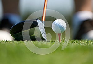 Up close image of a golf ball on tee with club