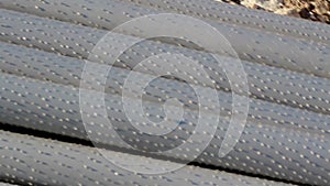 An up-close image of steel pipes piled