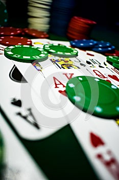 Up close photograph of playing cards and stacks of poker chips