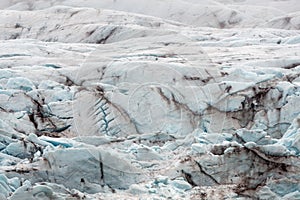 Up close of Vatnajokull glacier. Blue colors with ash pattern and texture in the glacier ice.