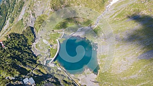 Up and down drone aerial view of the small and lower Lake Barbellino an alpine artificial lake. Italian Alps. Italy photo