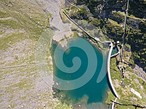 Up and down drone aerial view of the small and lower Lake Barbellino an alpine artificial lake. Italian Alps. Italy photo