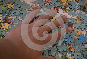 up of hand placing the puzzle , Hand holding missing jigsaw puzzle piece