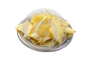 Up View Crispy thinly sliced potato chips in white bowl, on white background.