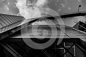 Up view on modern business office building and sky on the background. Urban exterior and tall perspective.