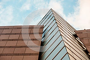 Up view on modern business office building and sky on the background. Urban exterior and tall perspective.