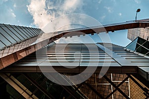 Up view on modern business office building and sky on the background. Urban exterior and tall perspective.