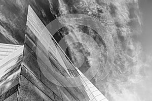 Up view on modern business office building and sky on the background. Urban exterior and tall perspective.