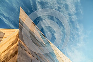 Up view on modern business office building and sky on the background. Urban exterior and tall perspective.