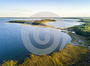 UpaÅ‚ty island by the sunset in Mamerki, Mazury district lake, P