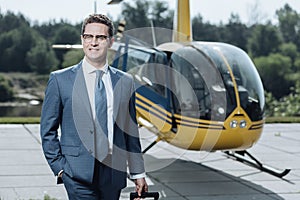 Upbeat CEO smiling while leaving heliport