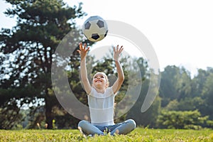 Upbeat girl throwing a ball in the air