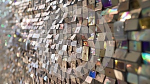 An upclose look at a large wall installation made from layers of discarded CDROMs and floppy disks creating a sparkling