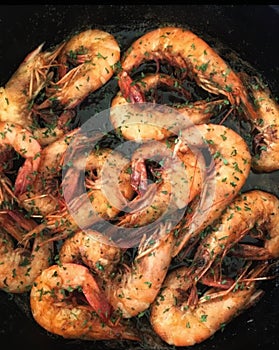 Seasoned cajun shrimp in a cast iron skillet photo