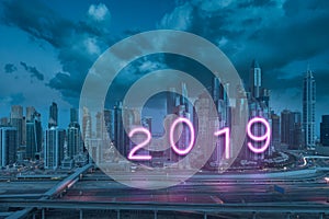 Upcoming 2019 year as neon sign on Dubai skyscrapers as backgound
