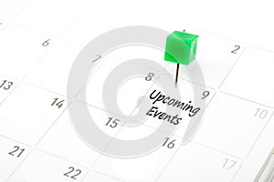 Upcoming Events written on a calendar with a green push pin to r