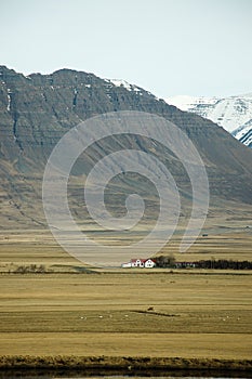 Upcountry house, rocky mountain, dry field, Iceland photo