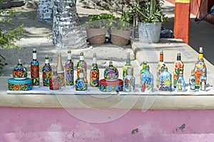 Upcycled bottles and tins display at a beachfront bar Santa Cruz Huatulco